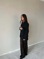 Woman wearing Valentina™ Luxe Kanten Broek with elegant lace details and a black blazer, showcasing a stylish and chic look.